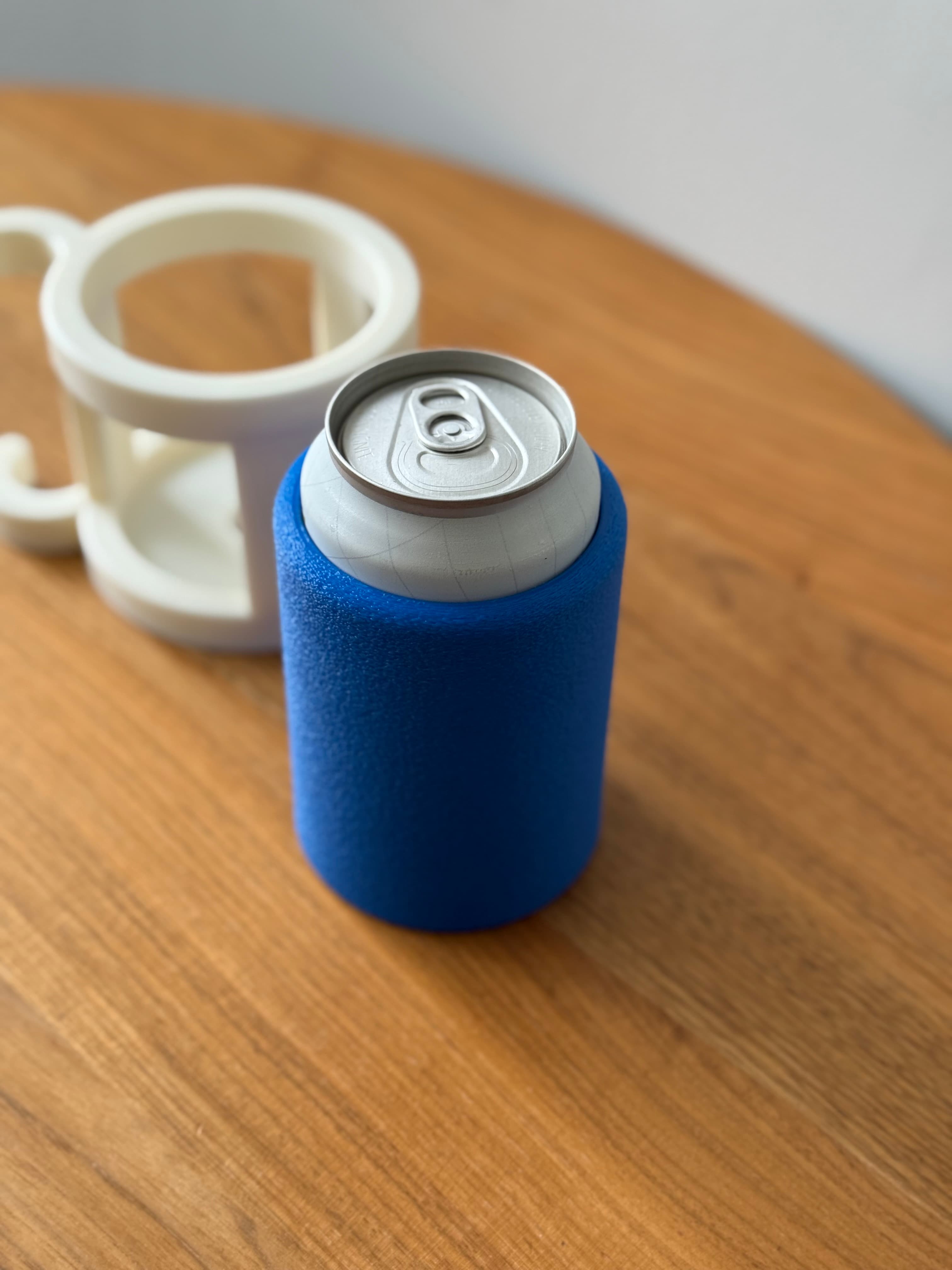 Emberforge Beer Koozie with ergonomic grip keeping a beer can cold